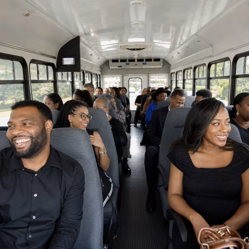 Group boarding a white charter bus for Private Event Transportation transportation in Indianapolis