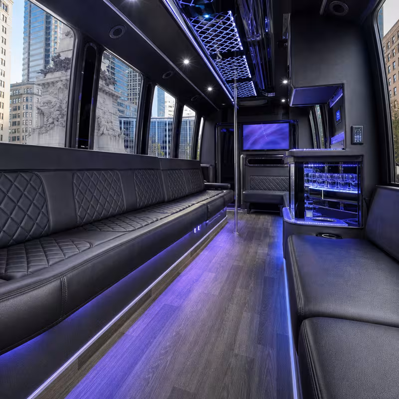 Party bus interior with wraparound leather seating and LED lighting in Indianapolis